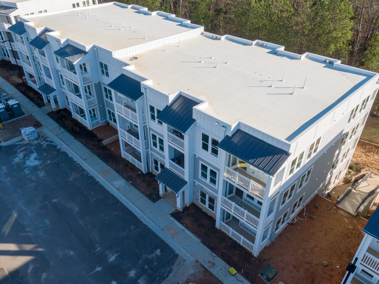 Aerial view of a multifamily building with a low slope roof