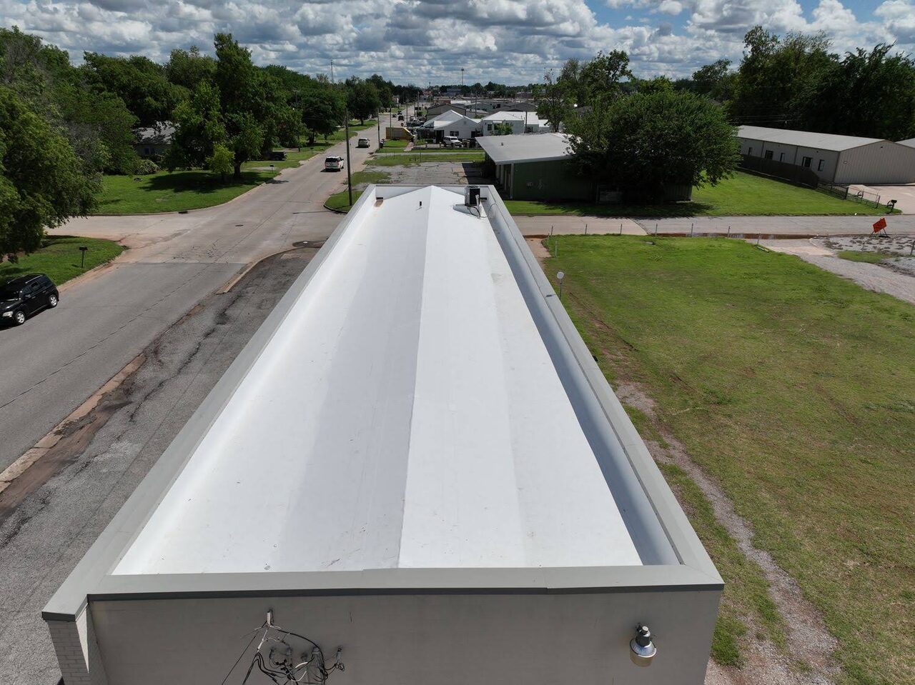 Drone view along the coping of a commercial low slope roof
