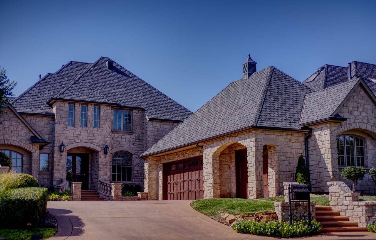 Large brick estate home with a new architectural shingle roof