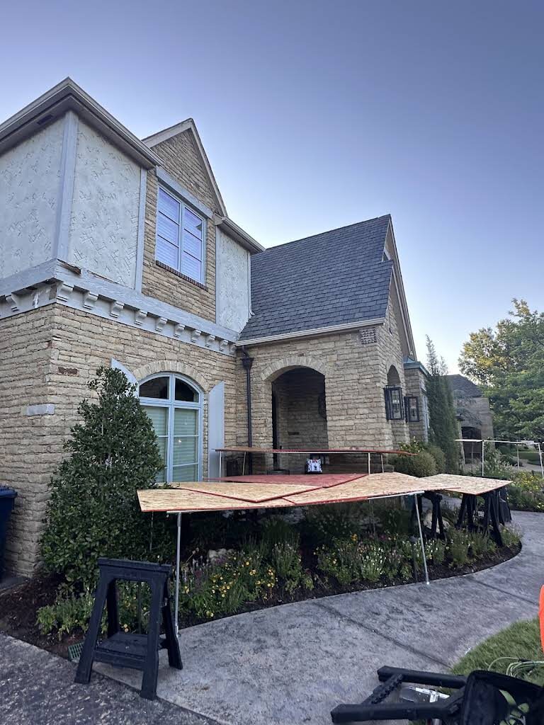 Protective staging and covers set up around a house before roofing work