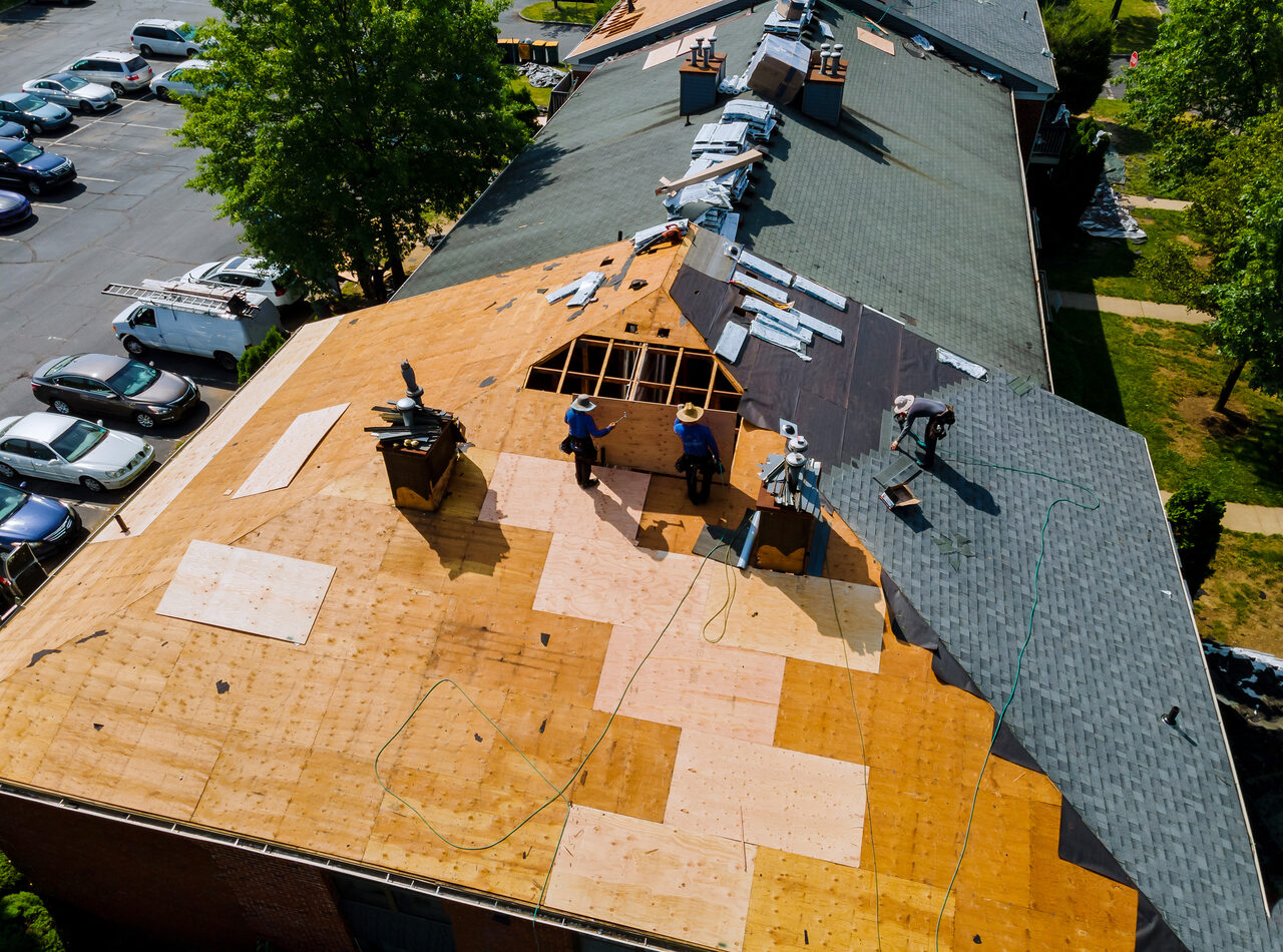 Aerial view of a roof stripped to the decking during replacement