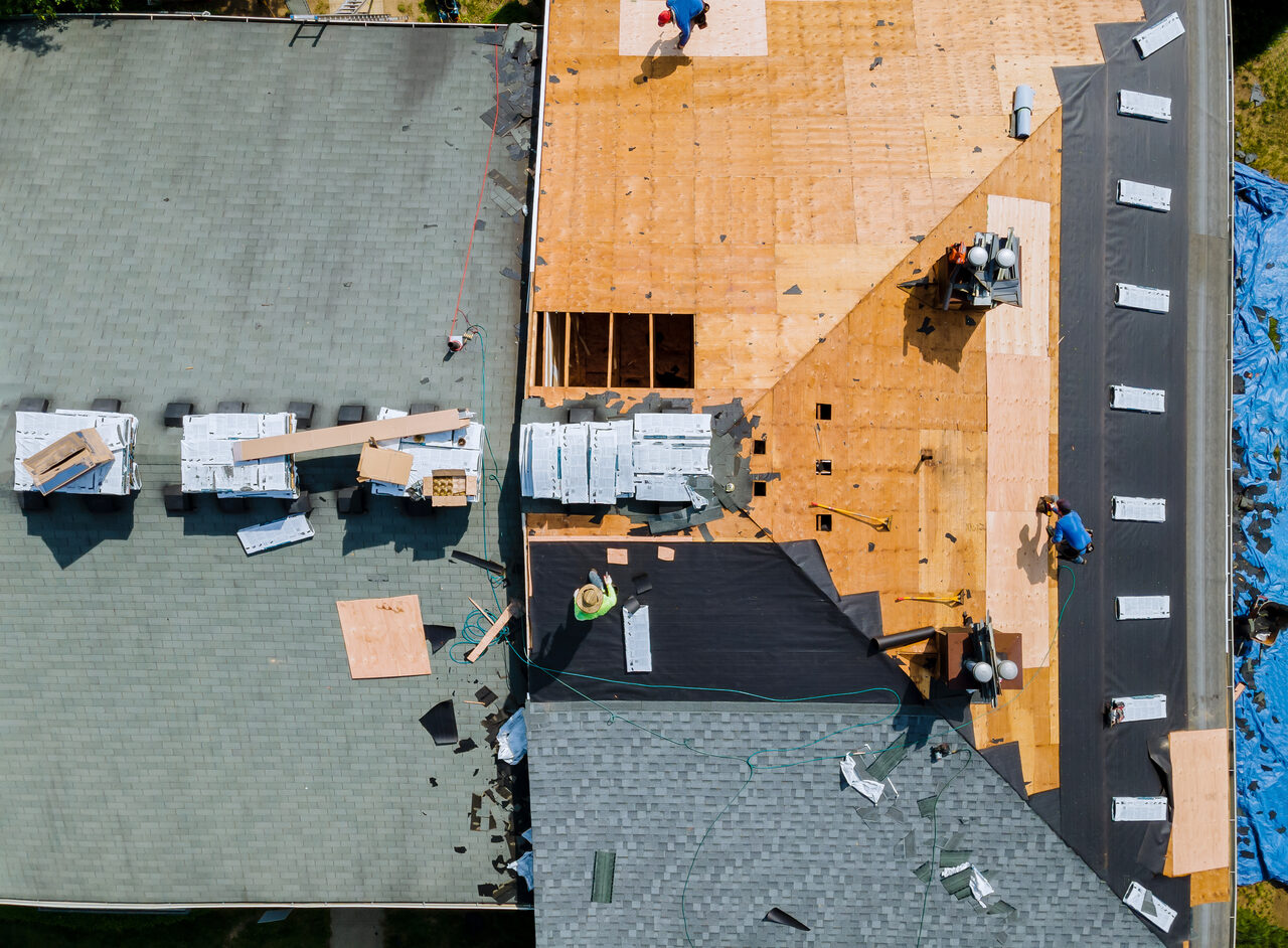 A residential roof stripped back to bare decking during a tear off