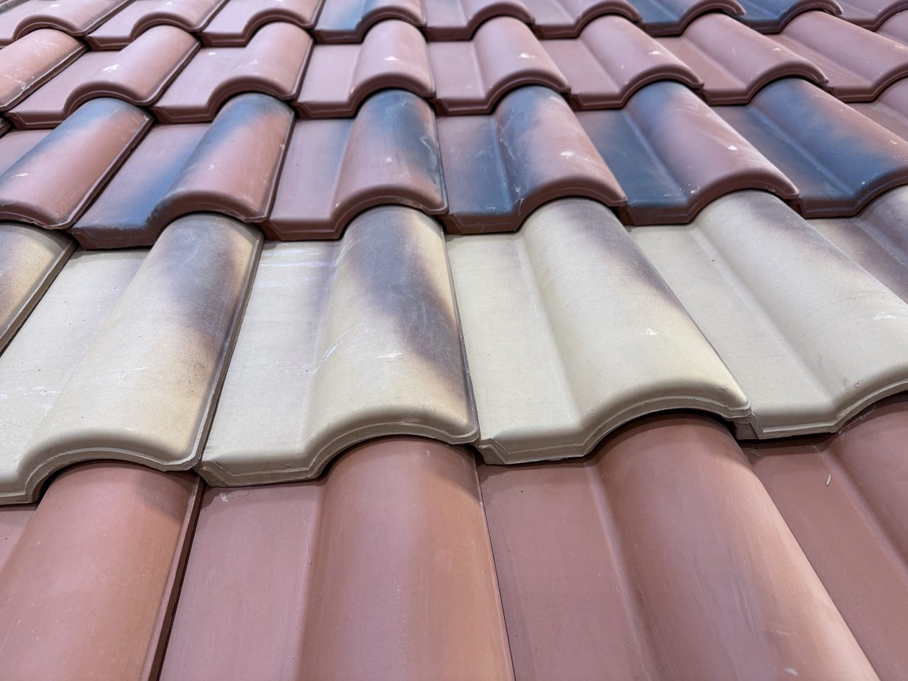 Close up of glazed ceramic roof tiles laid in courses