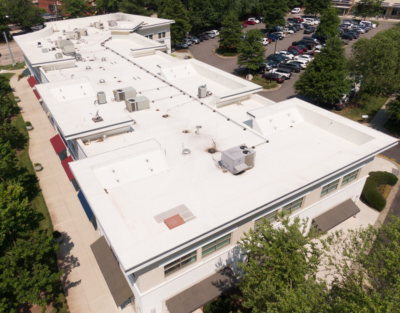 Aerial view of a white membrane roof with rooftop HVAC equipment